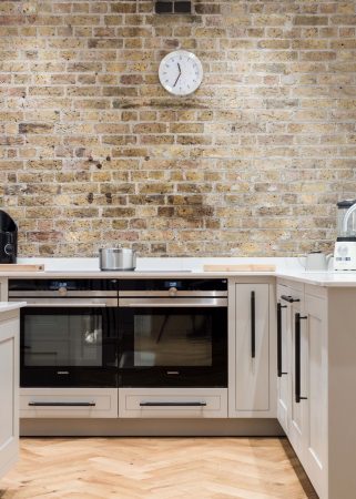 Modern kitchen with brick wall